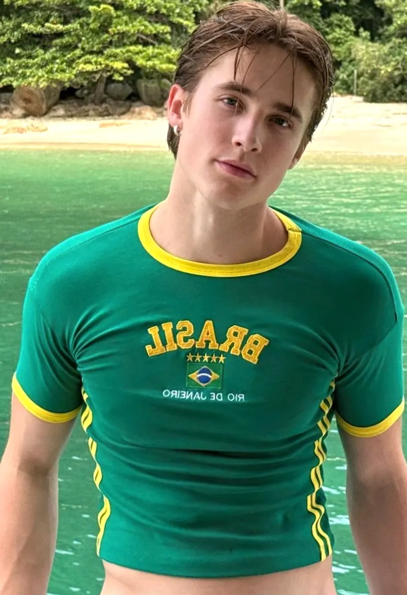 Young man in a Brasil Rio de Janeiro cropped t-shirt by a tropical beach.